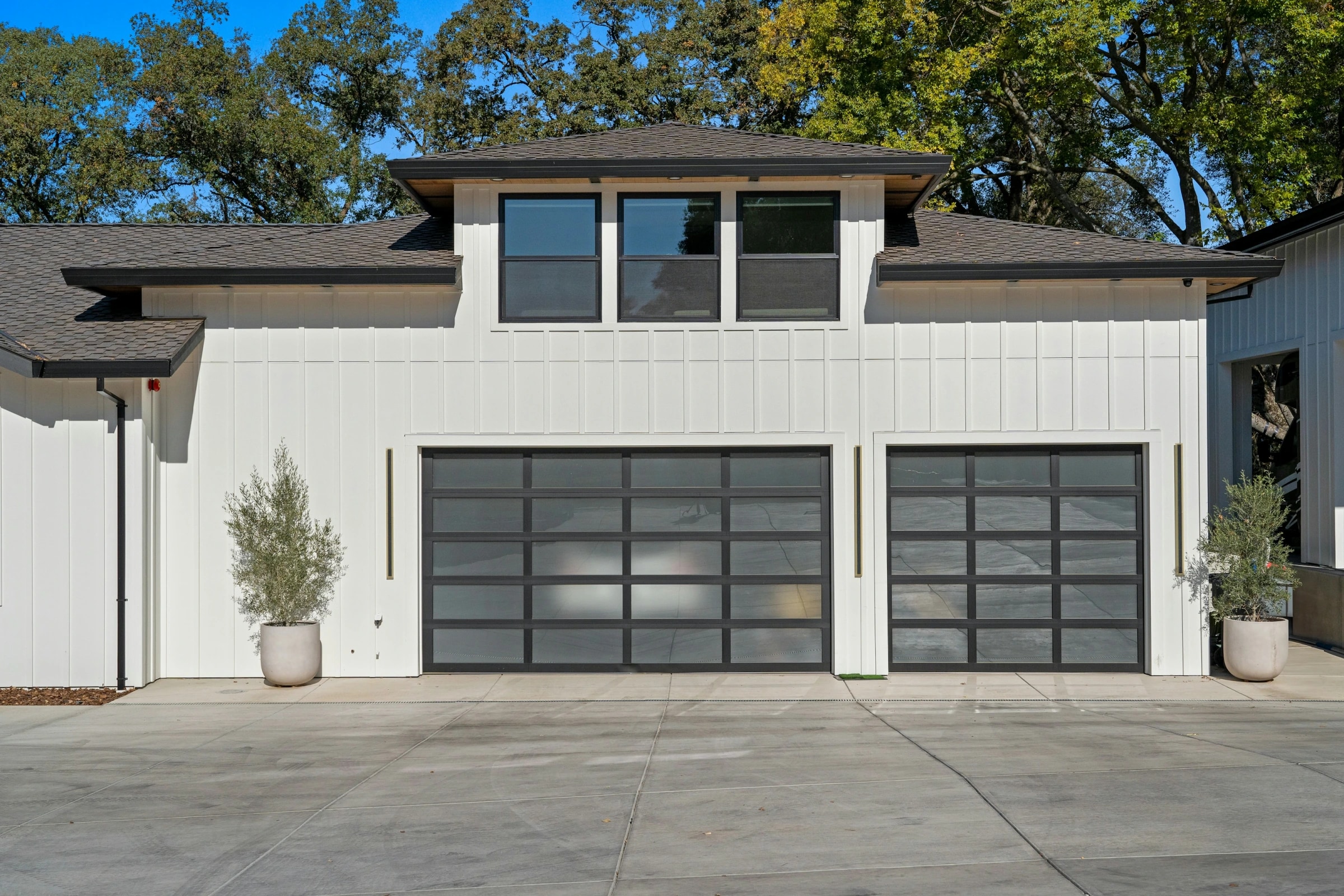 Modern white home with two premium glass-panel garage doors